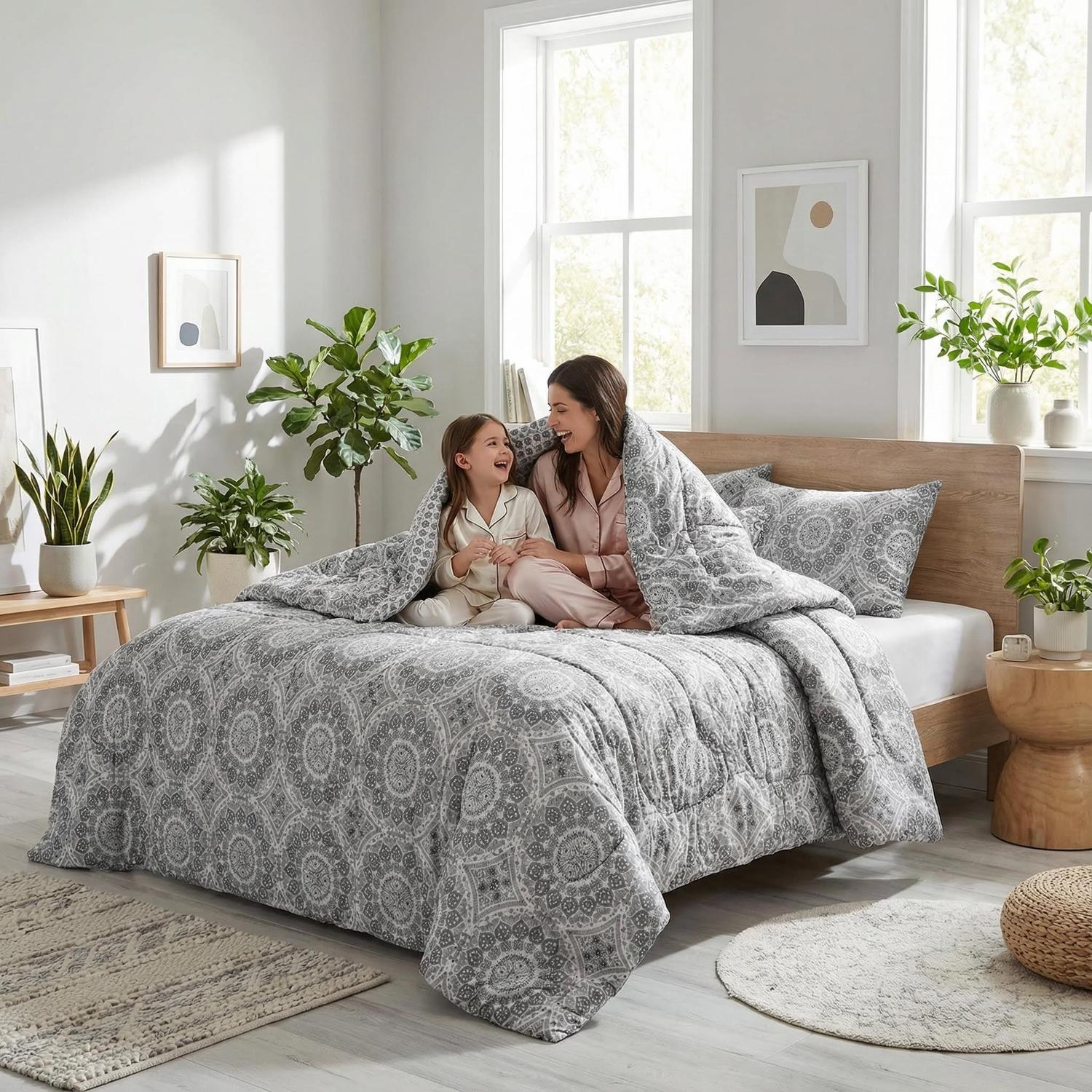 Grey Aztec reversible comforter set on a bed with a mother and child.