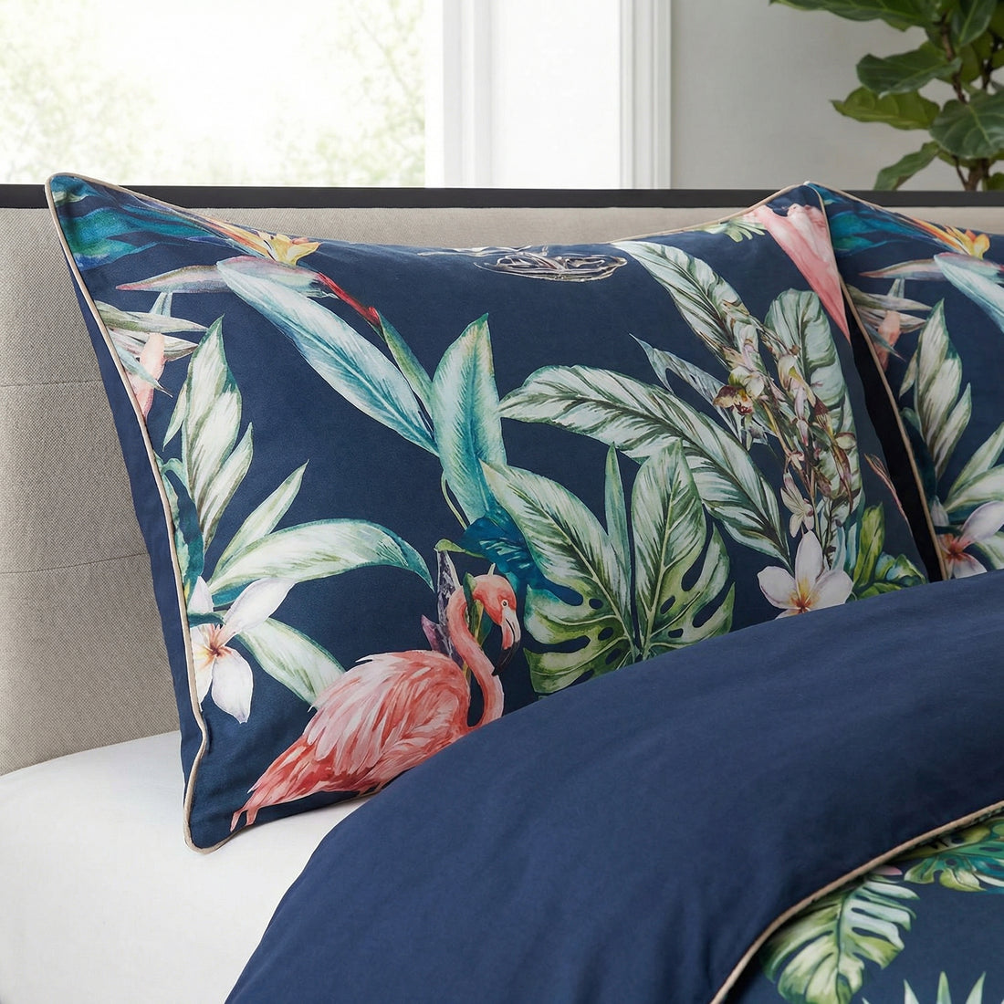 Reversible Egyptian cotton duvet cover with pink flamingos and tropical foliage on a navy blue background.