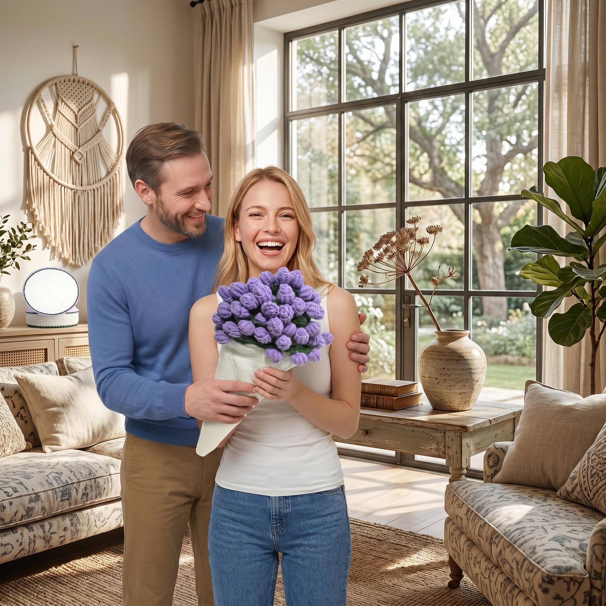 Happy woman holding a purple crochet flower bouquet, man smiling behind her in a cozy living room.