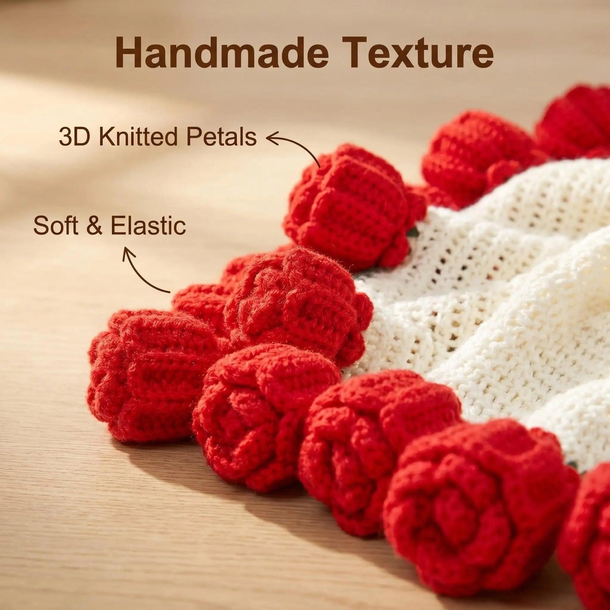 Close-up of a handmade knitted white blanket with soft, elastic 3D red crochet rose petals.