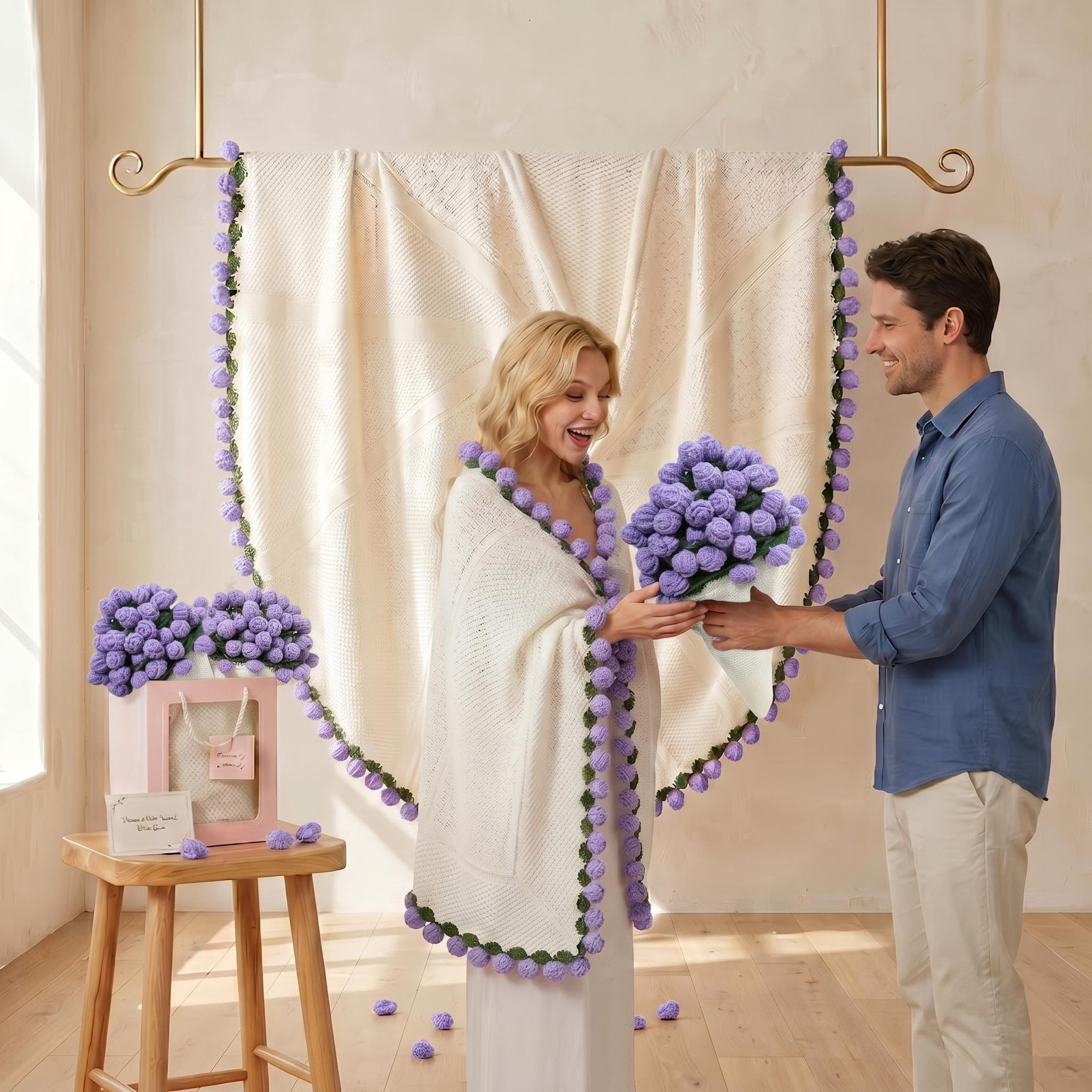 Woman in a white crochet blanket with purple pom-poms receiving a purple rose bouquet from a man.