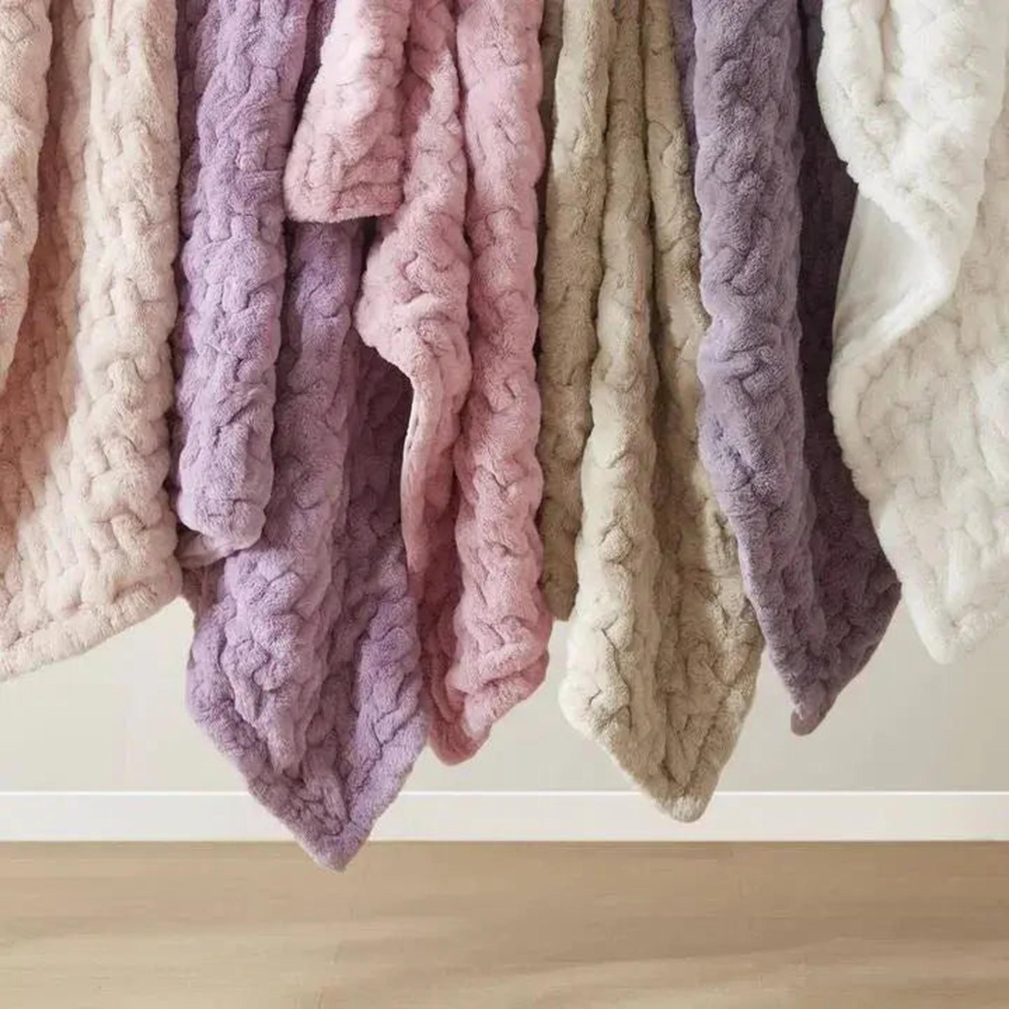 Soft ruched faux fur throw blankets in blush, lavender, pink, beige, purple, and white.