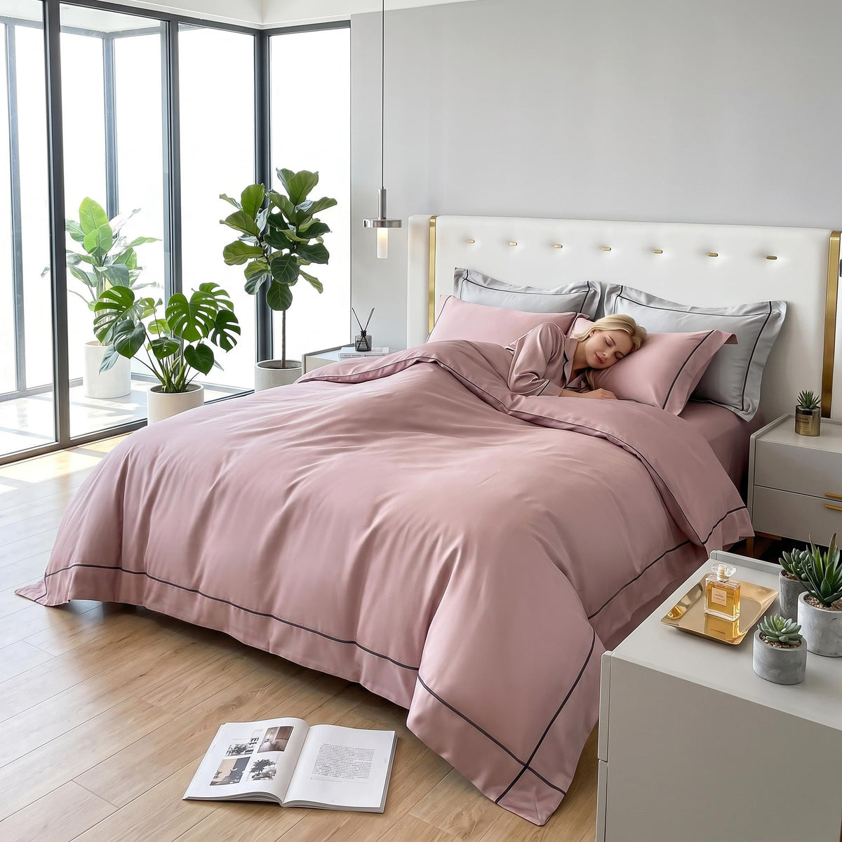 Dusty rose Egyptian cotton duvet cover set with elegant dark embroidery borders on a bed in a modern bedroom.