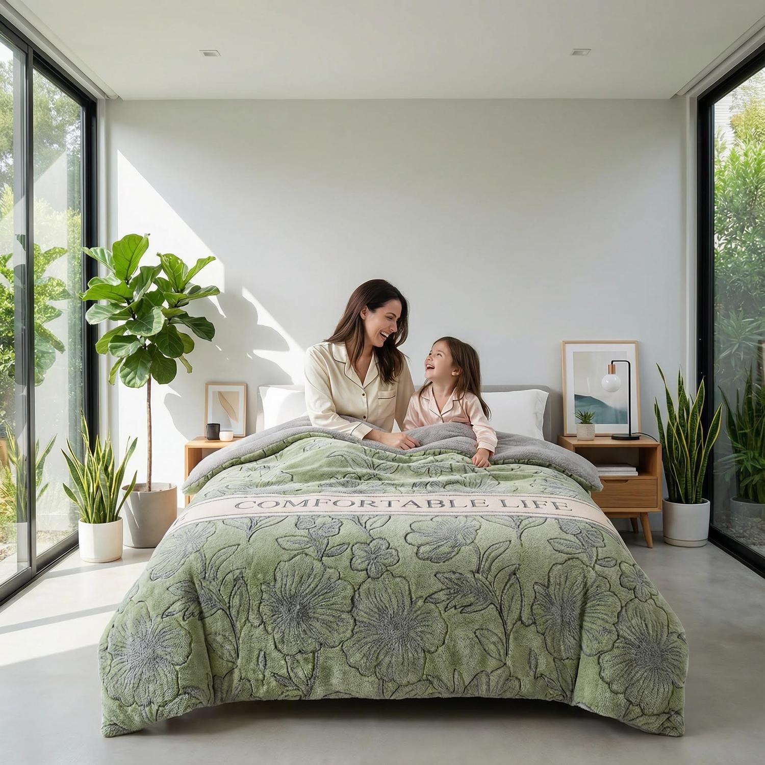Green floral velvet quilt with "COMFORTABLE LIFE" text, covering a bed where a mother and child sit.
