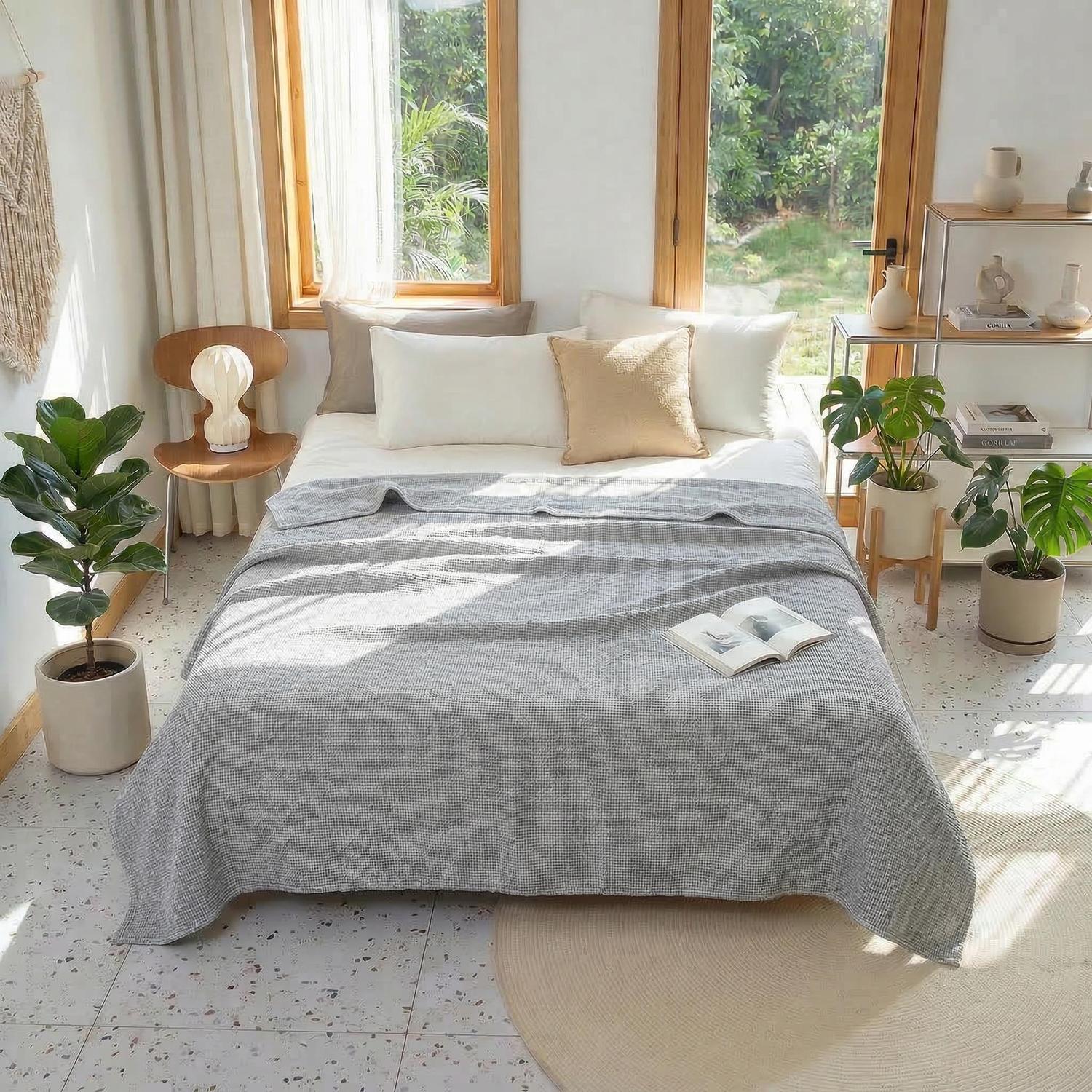 Light gray soft cotton bedspread with geometric knit texture on a bed in a bright, modern bedroom.