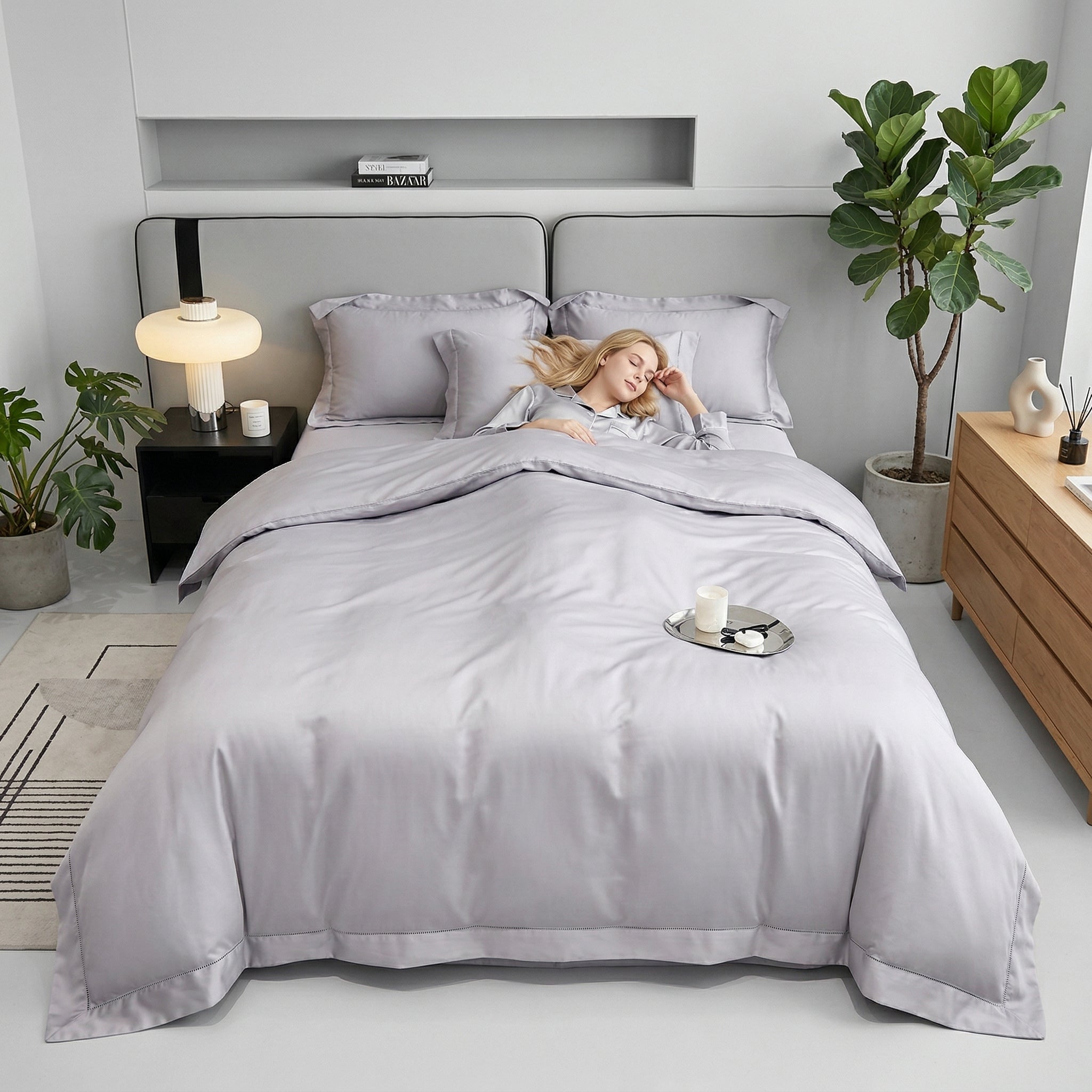 Woman sleeping in a soft, light gray solid color cotton duvet cover bedding set.