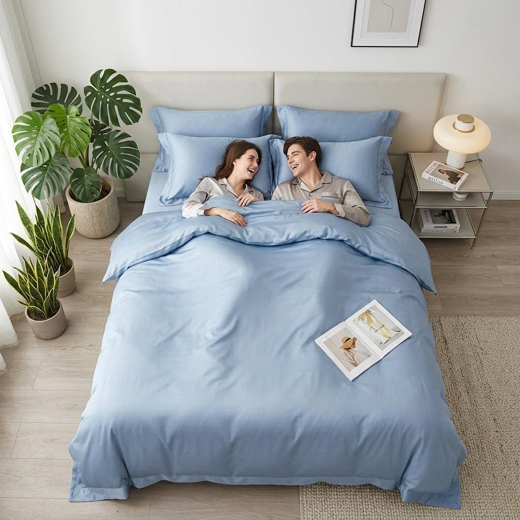 Couple smiling in a soft blue solid color cotton duvet cover bedding set.