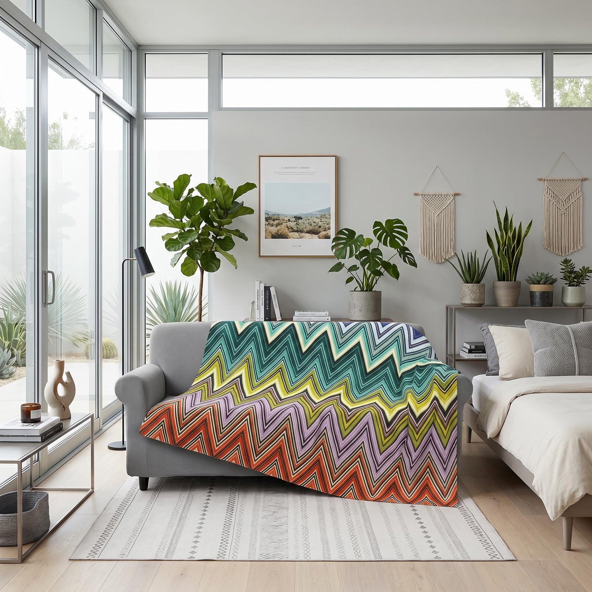 Solstice Zig Geometric Throw Blanket, multicolor zigzag pattern, draped over a gray sofa in a modern room.