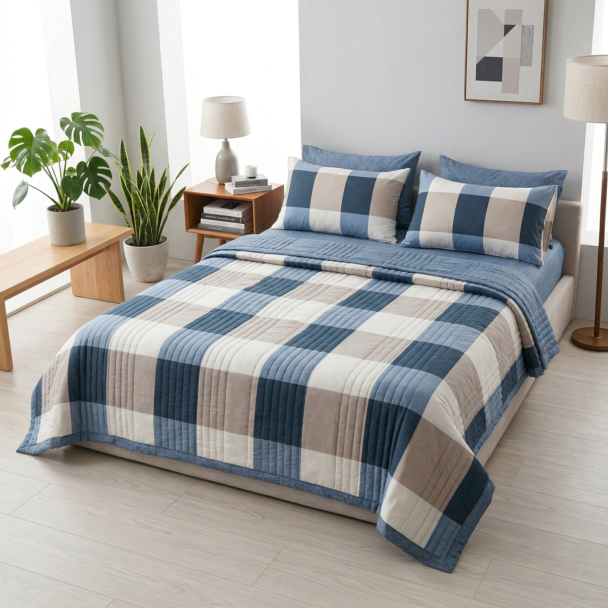 Blue and beige plaid microfiber quilt with matching pillowcases on a bed.