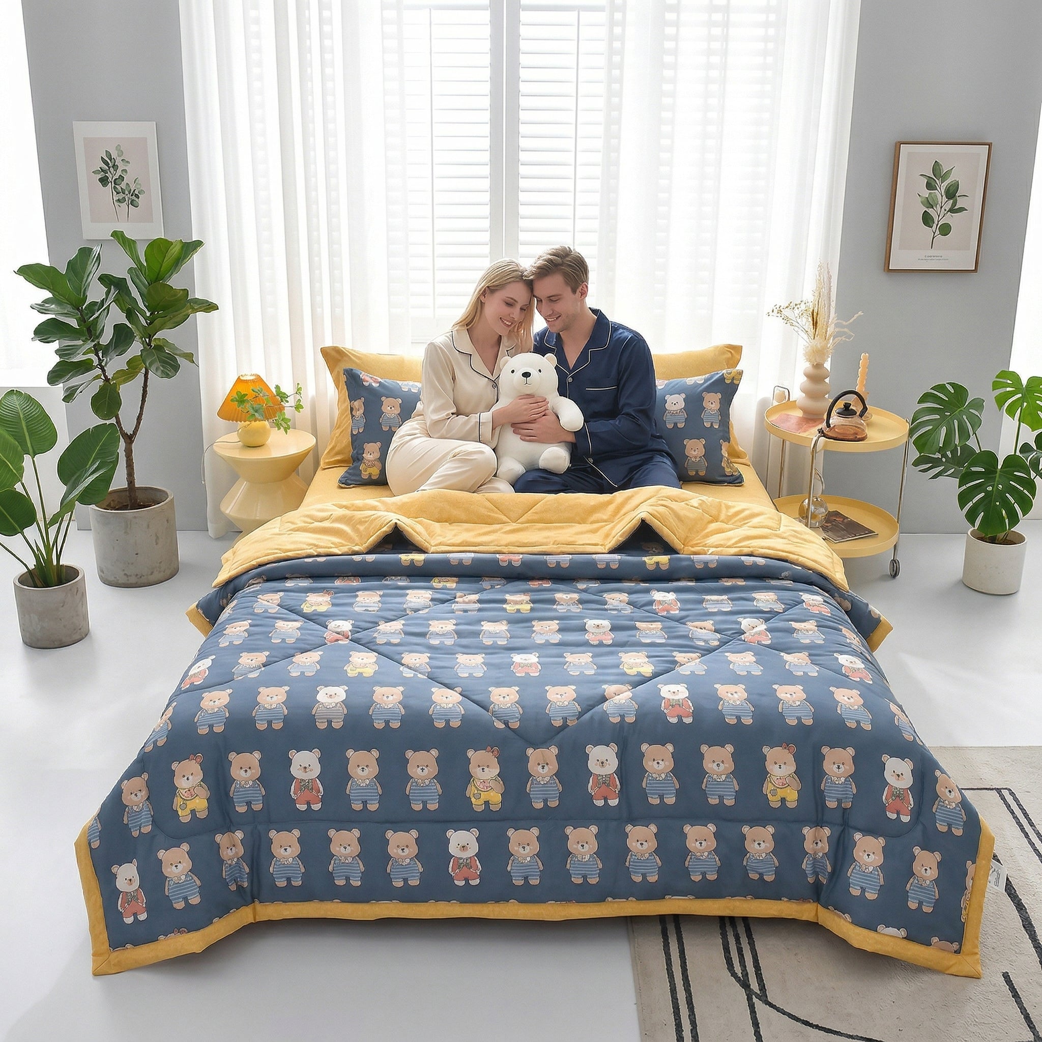 Couple on a bed with a blue and yellow Summer Breeze lightweight blanket featuring a cute bear pattern.