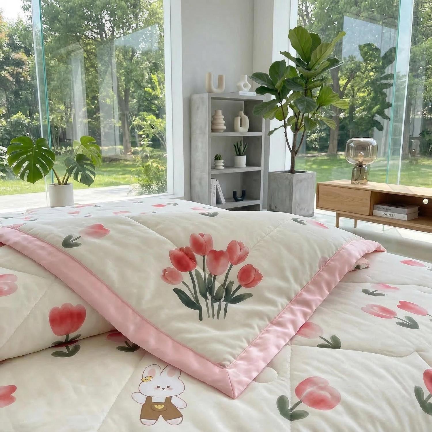 White ice silk quilt with pink tulips and a cute bunny design, featuring a pink border.