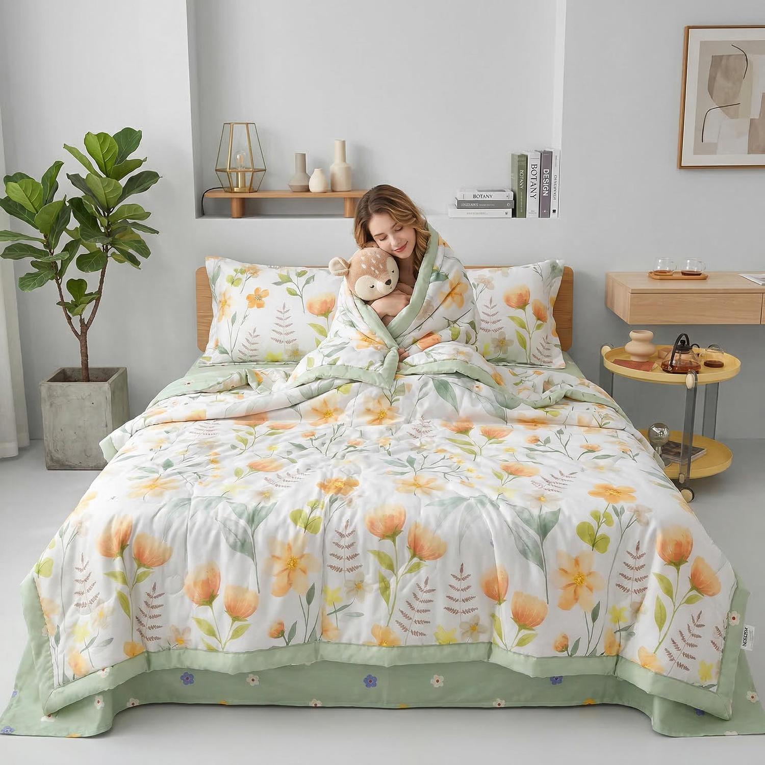 Woman on a bed wrapped in a white ice silk quilt with yellow and green floral print.