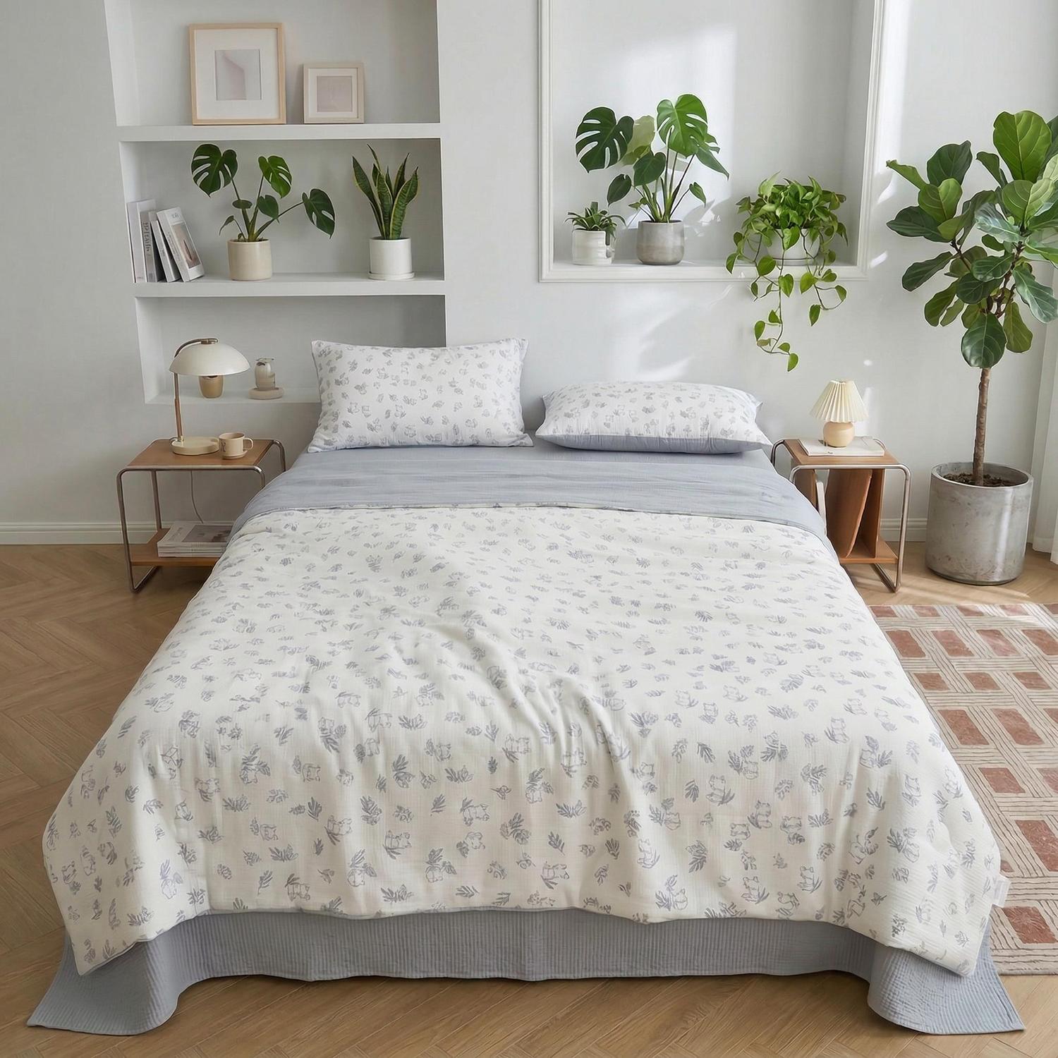 White Summer Inspired Quilt Bedding Set with subtle gray floral patterns, two pillowcases, and a light gray sheet.