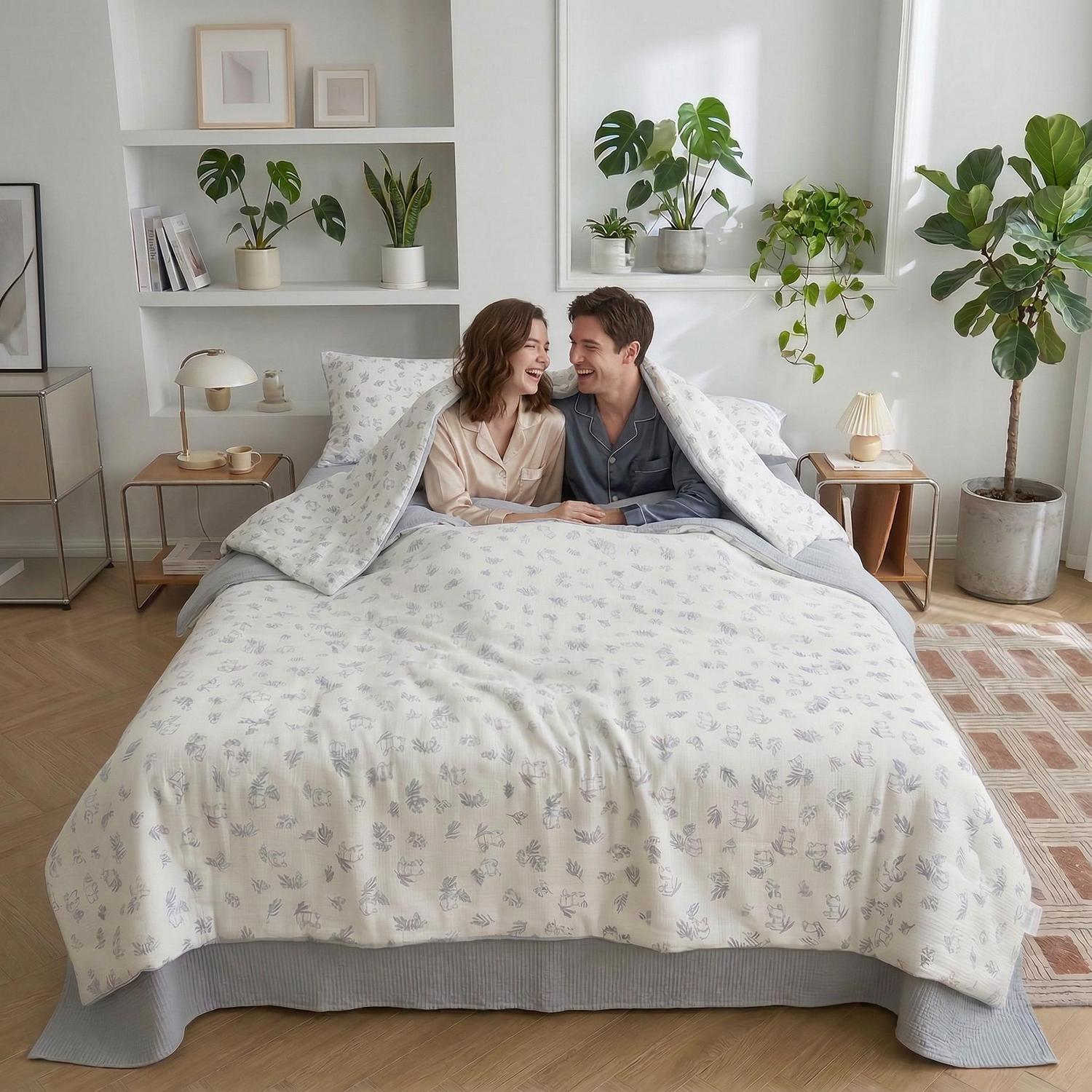 Happy couple in a white Summer Inspired Quilt Bedding Set with subtle gray floral patterns.
