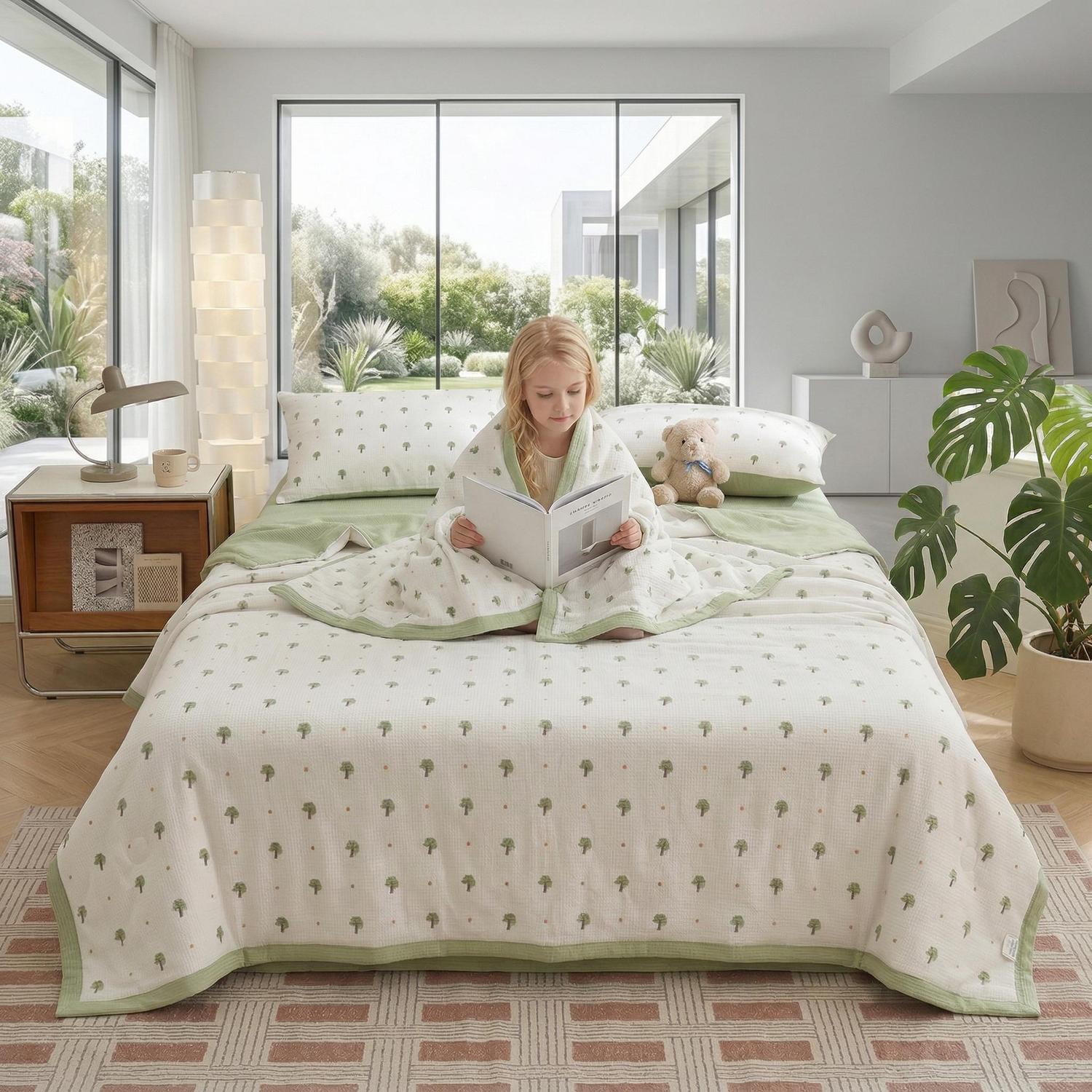 Girl on a bed with a white and green Summer Inspired Quilt Bedding Set, featuring a tree pattern.
