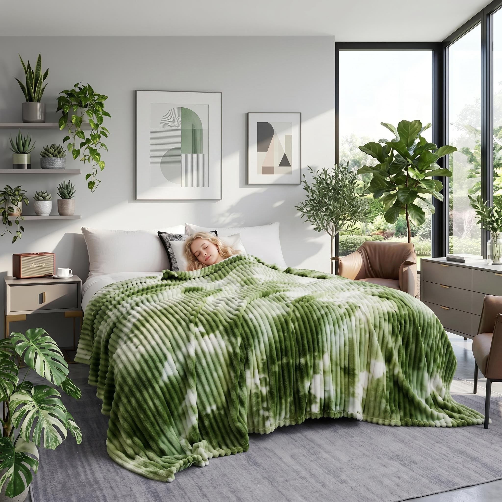 Green and white tie-dye flannel fleece blanket draped over a bed with a person sleeping.