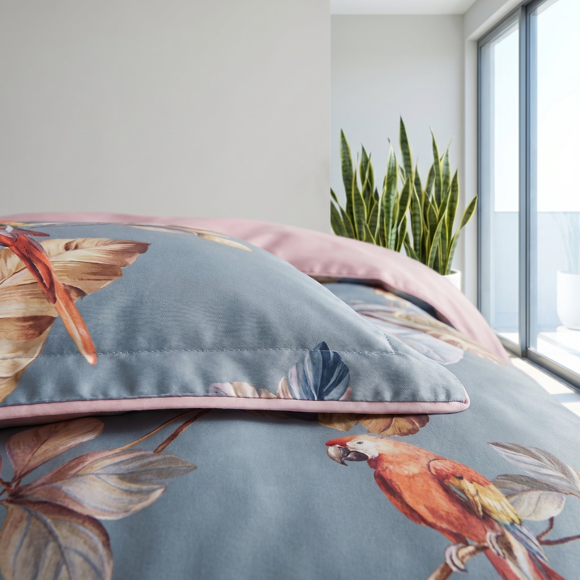 Tropical Parrots Bedding Set with vibrant parrots, warm leaves on a blue-grey microfiber duvet and pillow, dusty pink edges.