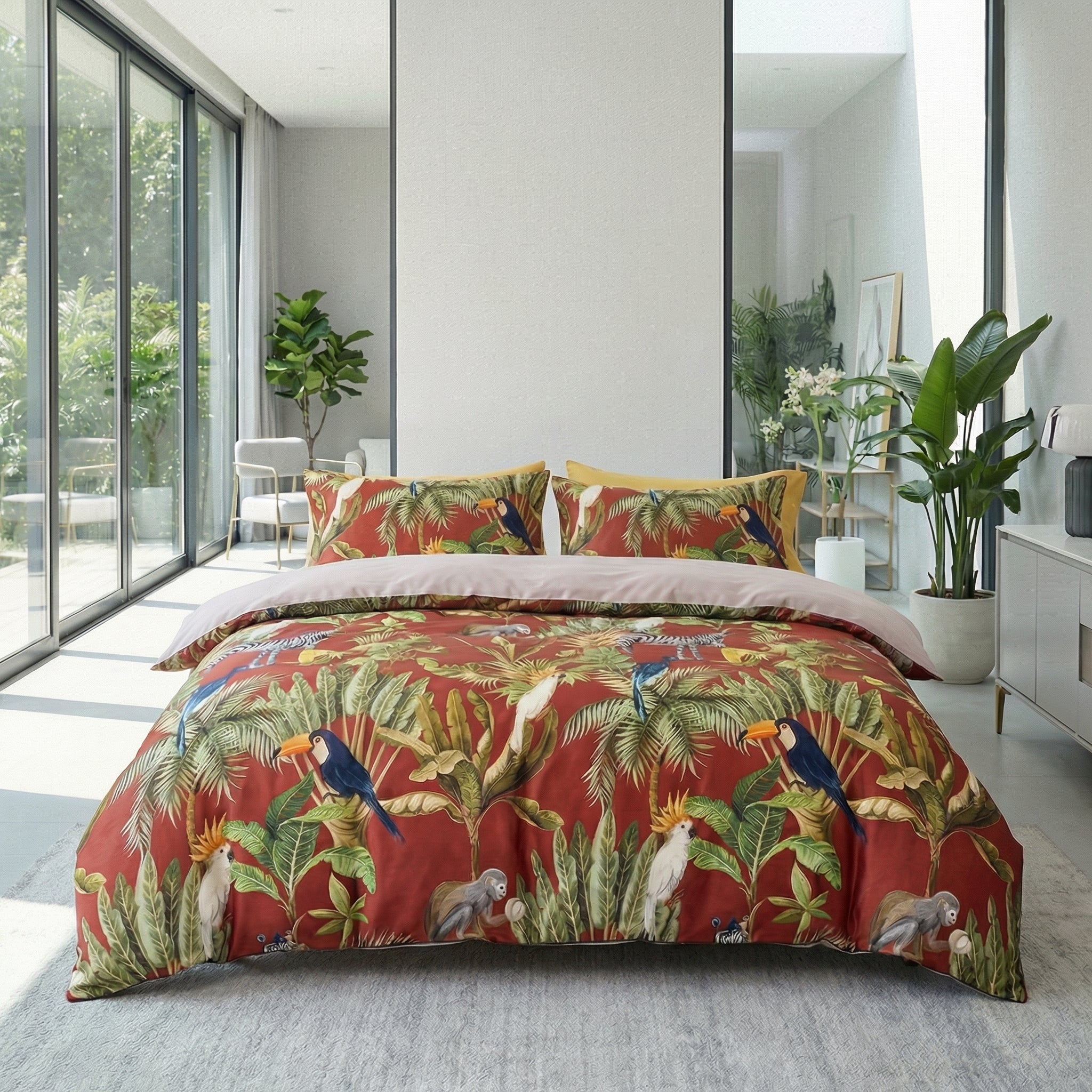 Tucano Red Egyptian cotton bedding set with tropical foliage and toucan motifs on a queen-sized bed.