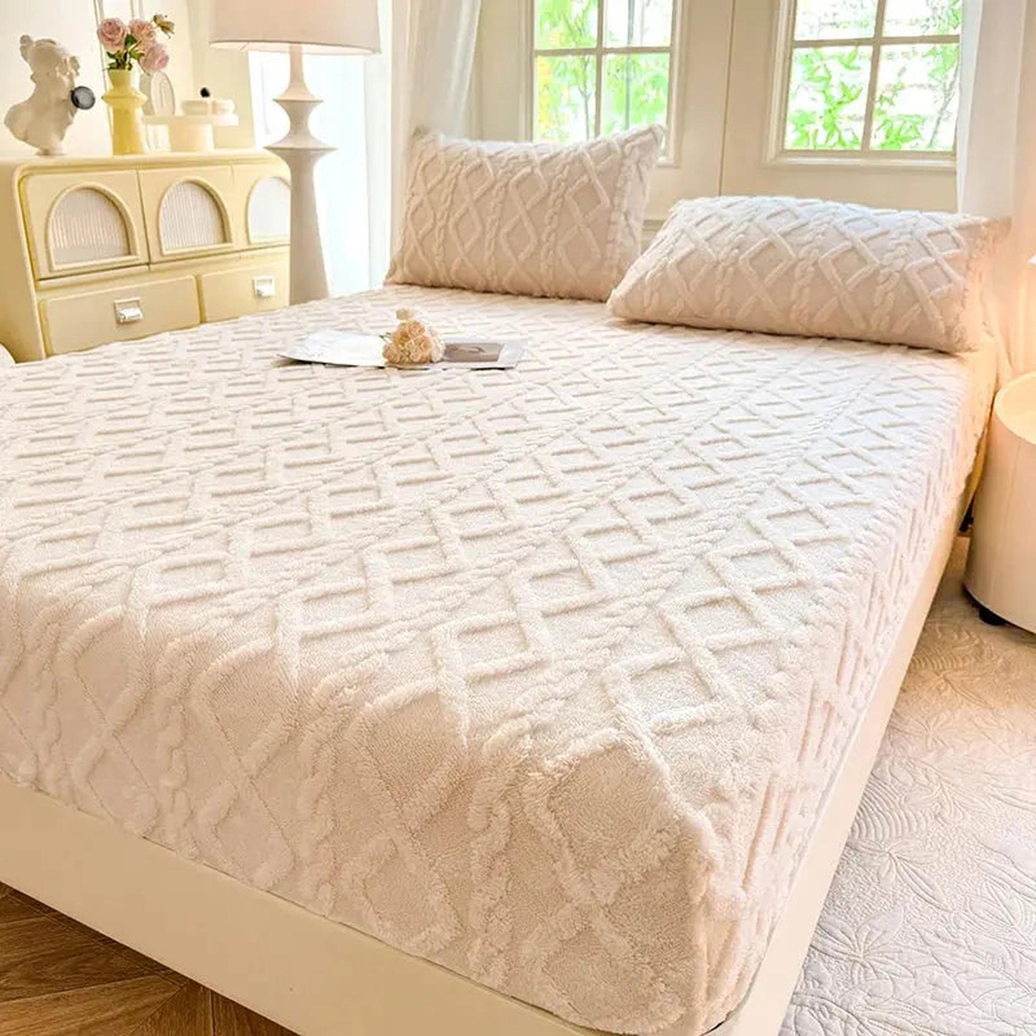 Cream coral fleece fitted bed sheet with a textured ribbed diamond pattern, shown with matching pillowcases.