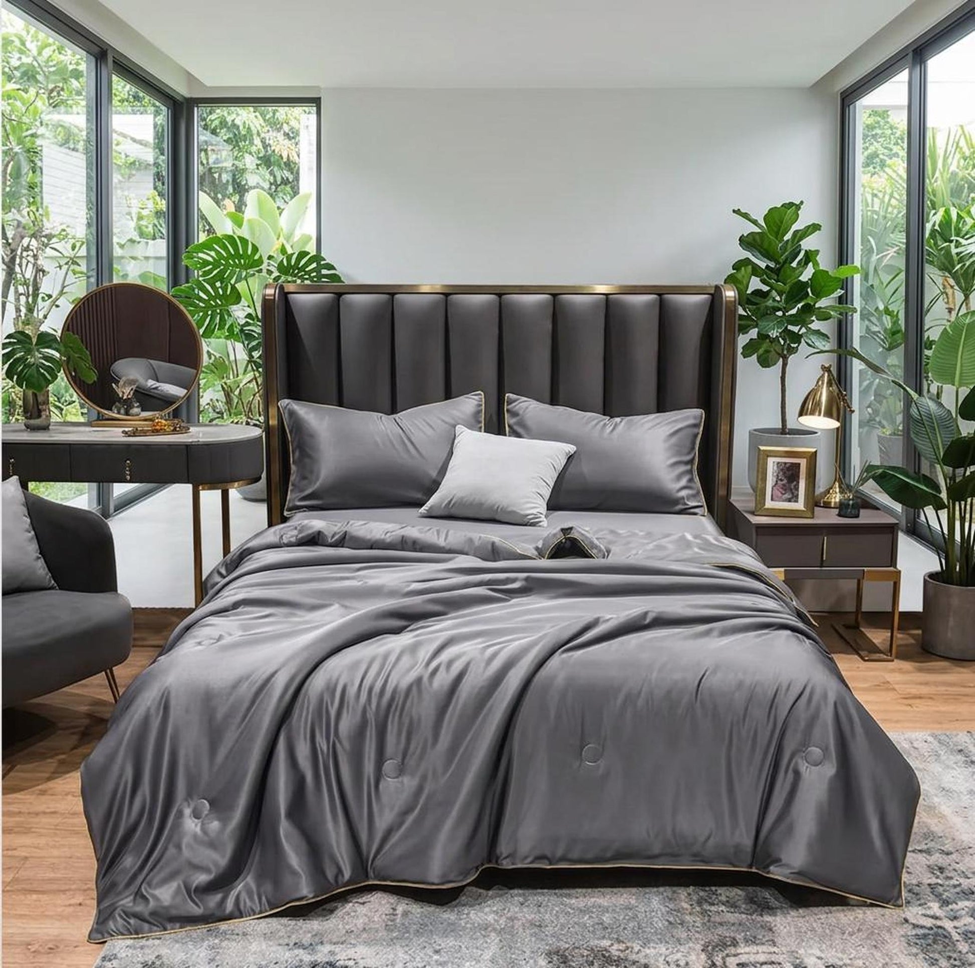 Gray washed silk summer quilt set with subtle embroidery on a bed in a modern bedroom.
