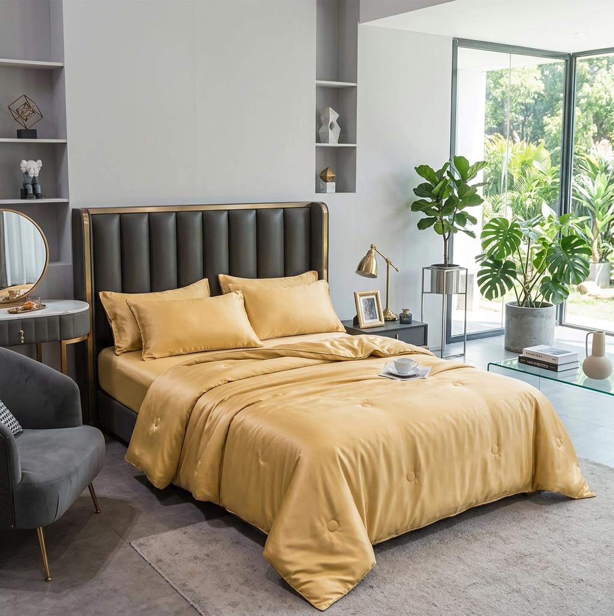 Golden washed silk summer quilt set with embroidered finish on a bed in a modern bedroom.