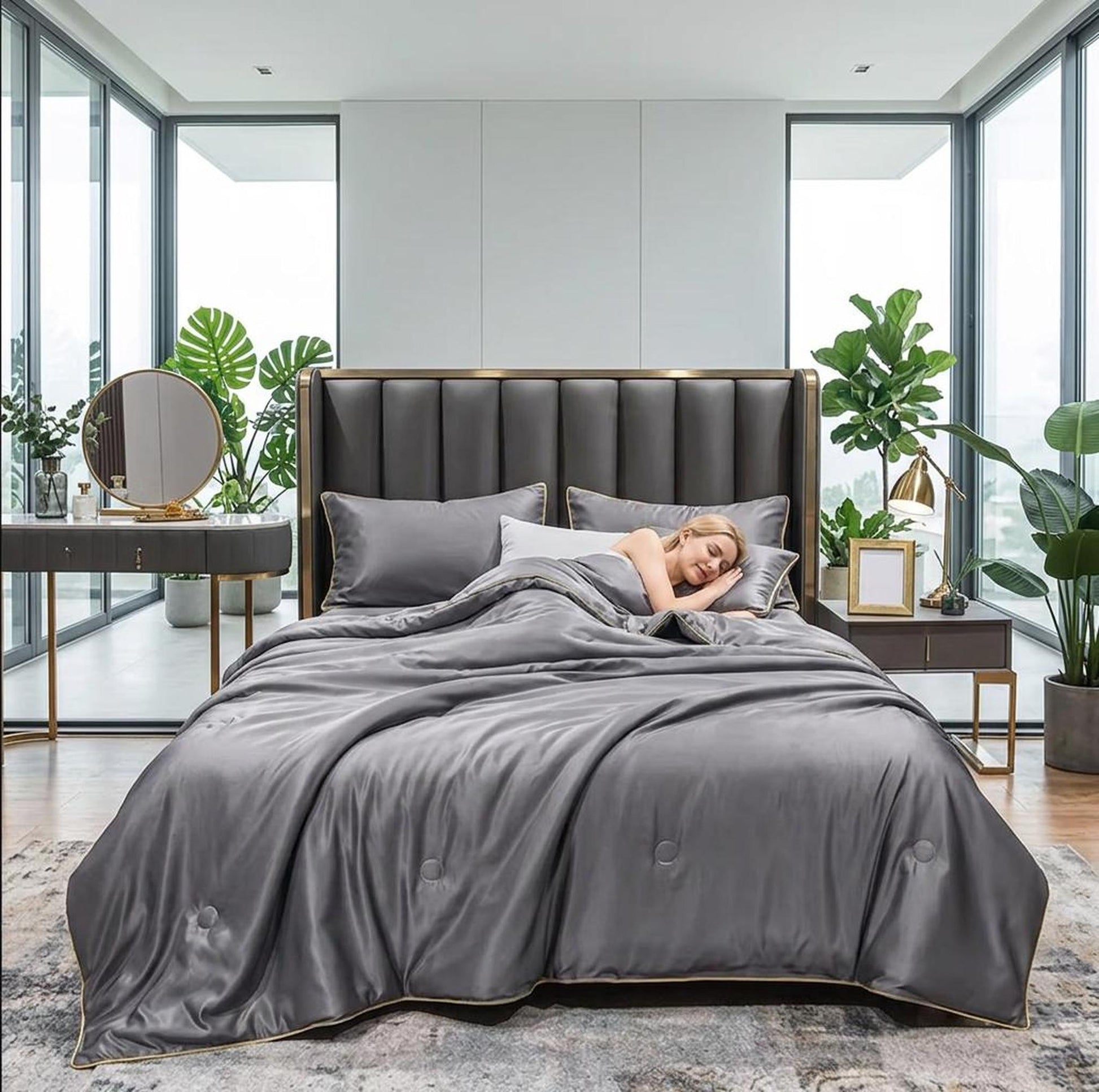 Gray washed silk summer quilt set with embroidered trim on a bed in a modern bedroom.