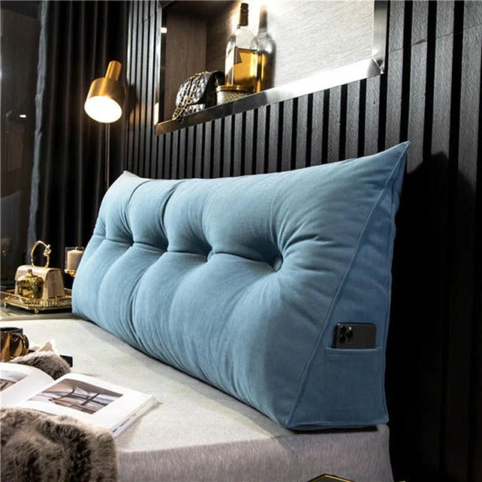 Light blue wedge pillow for back support with tufted design and side phone pocket.