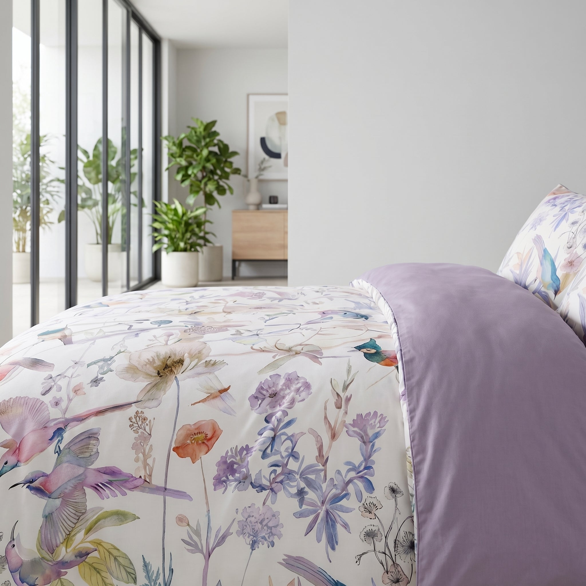 Whimsical Birds Bedding Set: white cotton duvet cover with playful birds, florals, and a reversible lilac underside.
