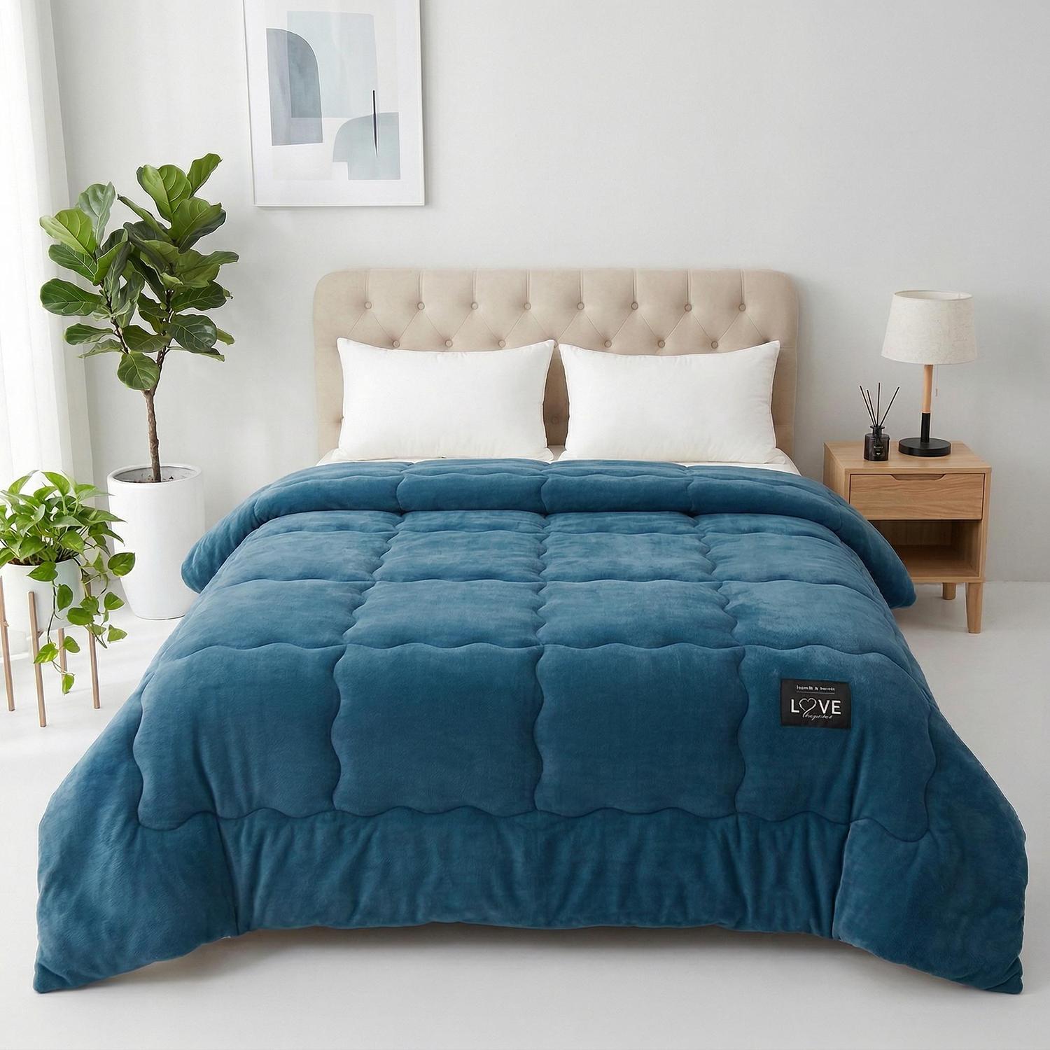 Soft blue quilted polyester Winter Warm Quilt Blanket on a bed with white pillows.