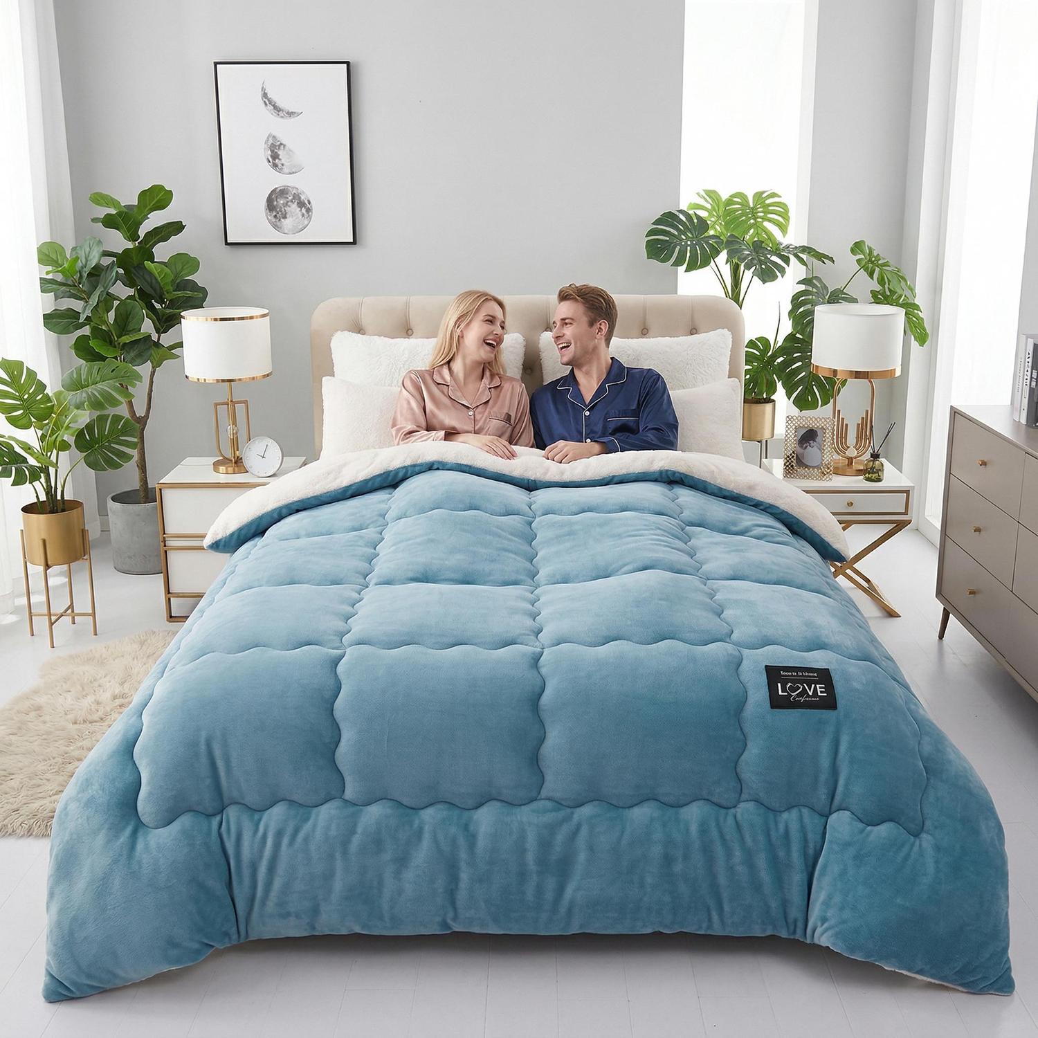 Cozy couple under a plush blue quilted blanket with a white sherpa lining.