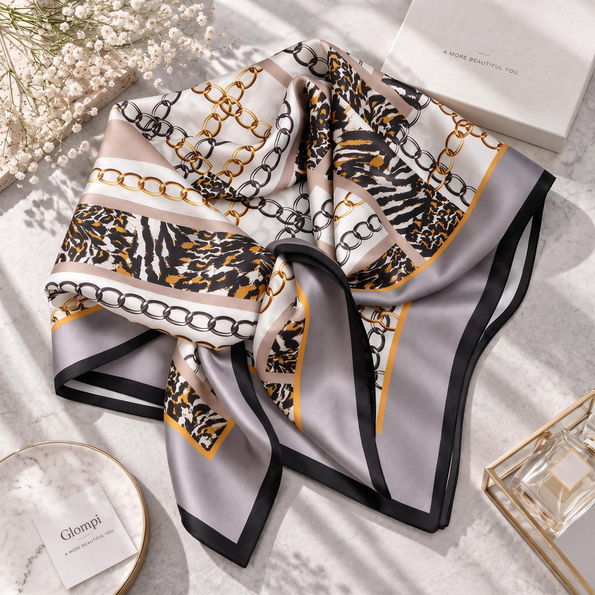 88x88cm square mulberry silk scarf featuring a gold chain and animal print pattern in beige, brown, and black.