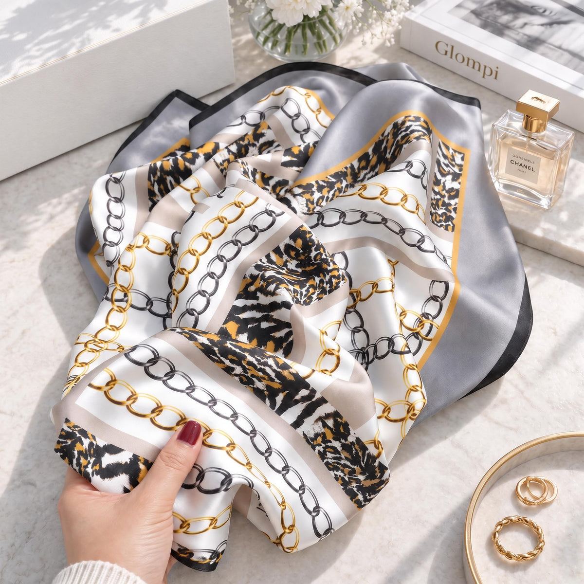 88x88cm square mulberry silk scarf featuring a gold chain and animal print pattern in beige, brown, and black tones.